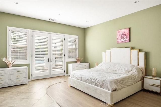 tiled bedroom with french doors and access to outside