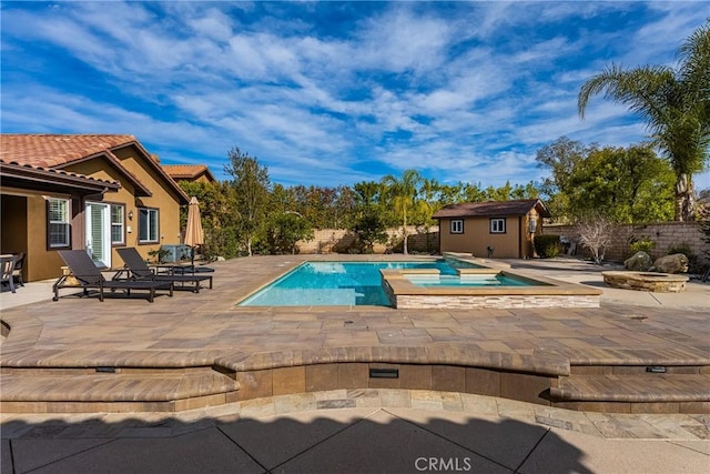 view of pool featuring an in ground hot tub, a storage unit, and a patio