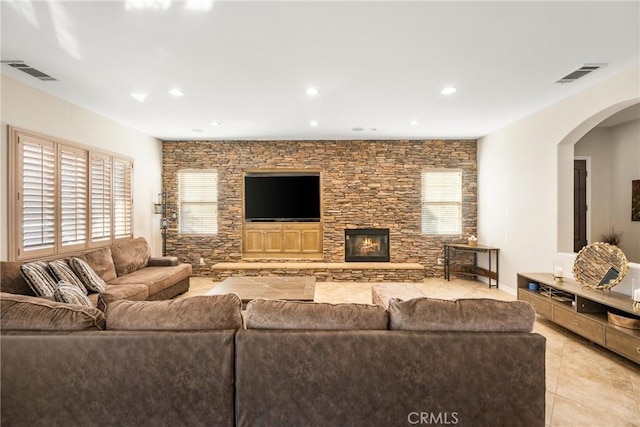 living room featuring a fireplace and light tile patterned floors