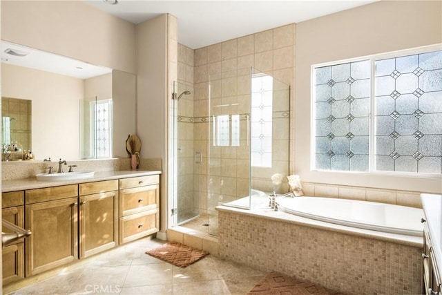 bathroom featuring vanity, tile patterned floors, and plus walk in shower