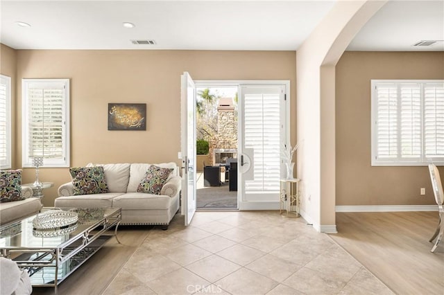 living room with light tile patterned floors and a healthy amount of sunlight