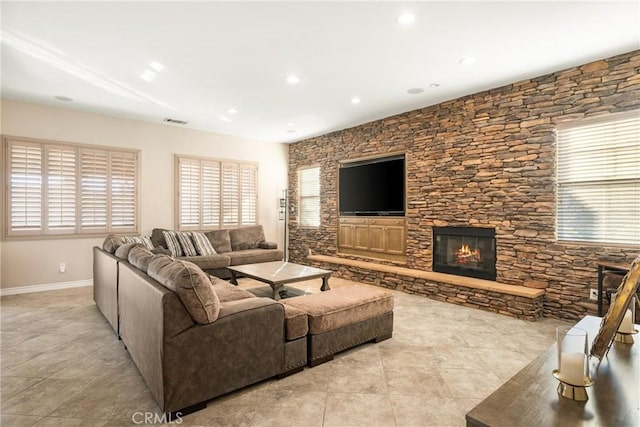 tiled living room featuring a fireplace and a wealth of natural light