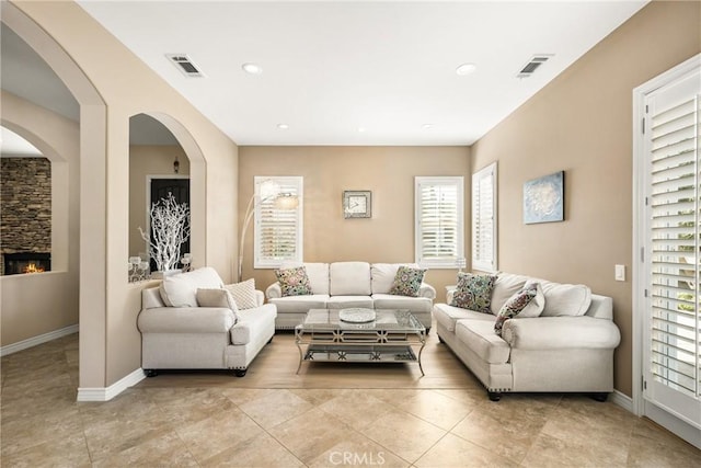 living room featuring light tile patterned flooring and a fireplace