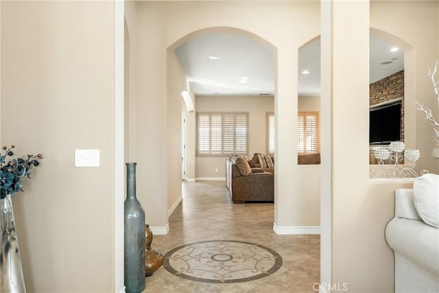 hall featuring light tile patterned floors