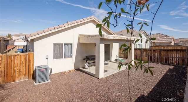 rear view of property with a patio and cooling unit