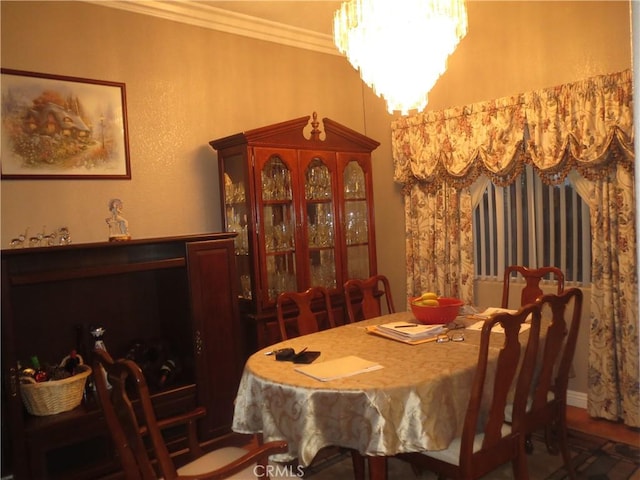 dining room featuring a chandelier and crown molding