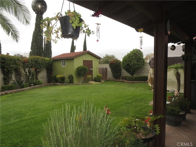 view of yard with an outdoor structure and fence