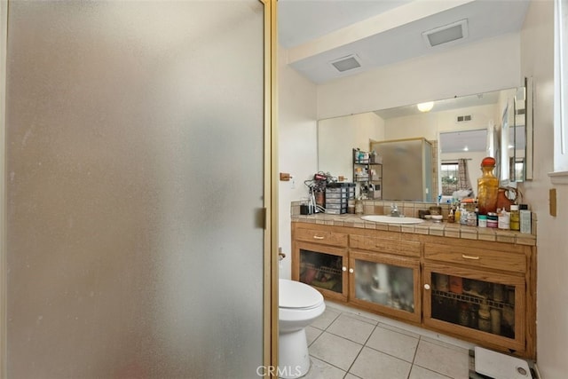 bathroom with vanity, tile patterned flooring, and toilet