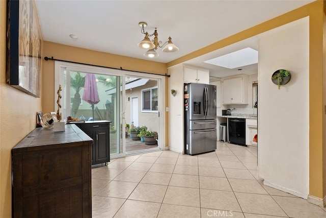 kitchen with white cabinetry, stainless steel fridge with ice dispenser, light tile patterned floors, dishwasher, and a notable chandelier