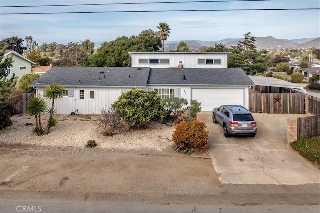 front facade with a garage and a mountain view