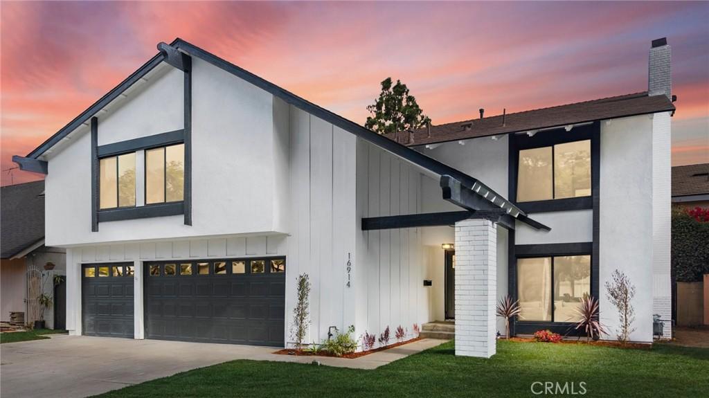 modern home with a garage and a lawn