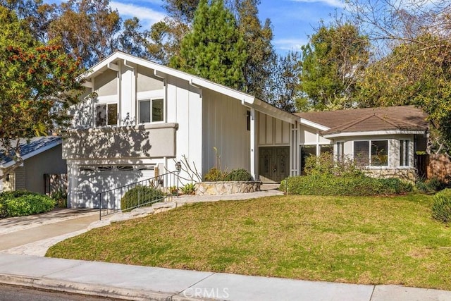 view of front of house featuring a garage and a front lawn