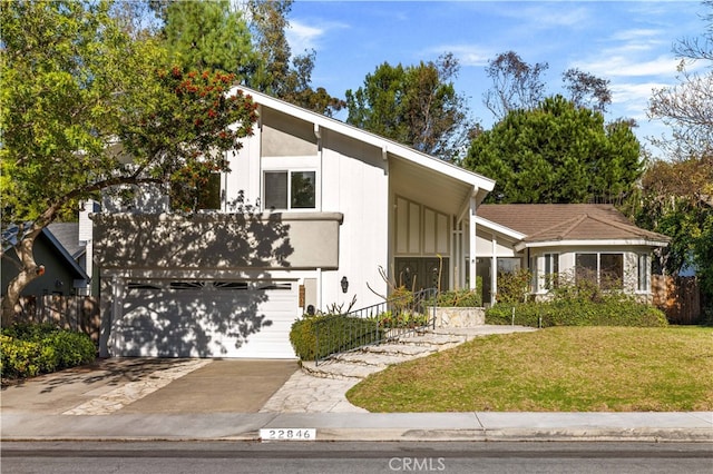 view of front of property featuring a garage and a front yard