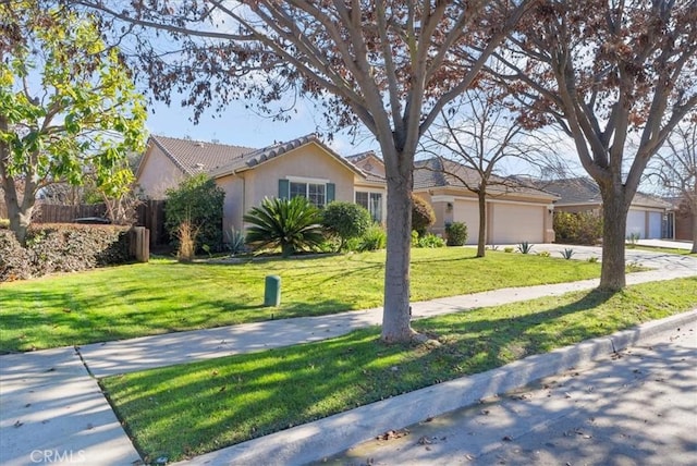 ranch-style house with a garage and a front yard