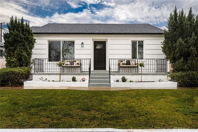 view of front of house featuring a front yard and covered porch