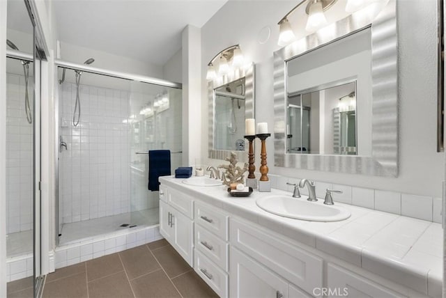 bathroom with vanity, an enclosed shower, and tile patterned flooring