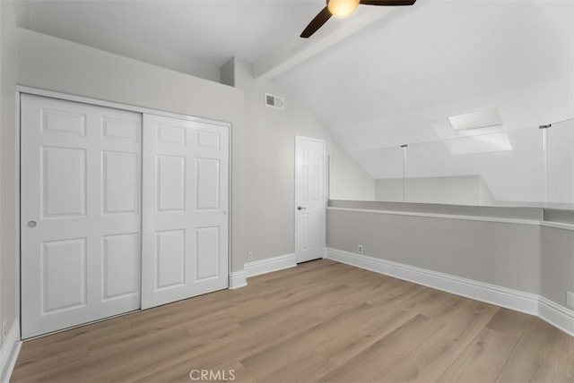 bonus room featuring vaulted ceiling with beams, ceiling fan, and light hardwood / wood-style flooring