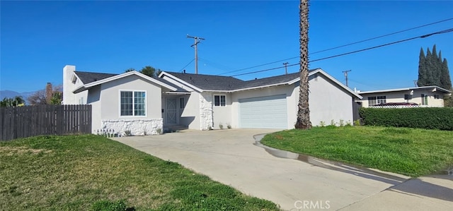 ranch-style home featuring fence, driveway, an attached garage, and stucco siding