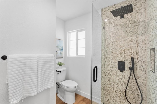 5594 Denver St, Montclair, CA 91763 - bathroom with baseboards, wood finished floors, a shower stall, and toilet
