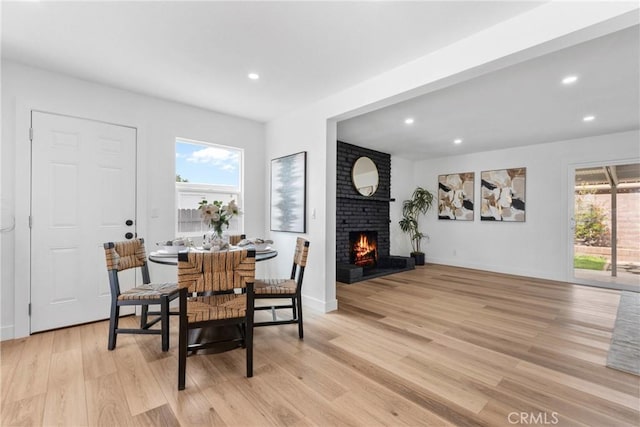 5594 Denver St, Montclair, CA 91763 - dining area with light wood-type flooring, plenty of natural light, a brick fireplace, and recessed lighting