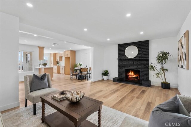 5594 Denver St, Montclair, CA 91763 - living room featuring a fireplace, light wood finished floors, and recessed lighting