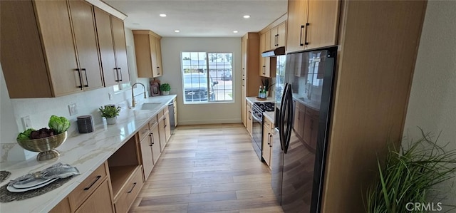 5594 Denver St, Montclair, CA 91763 - kitchen featuring light wood finished floors, under cabinet range hood, range with gas cooktop, a sink, and black fridge with ice dispenser