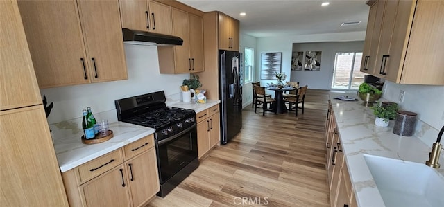 5594 Denver St, Montclair, CA 91763 - kitchen featuring black appliances, under cabinet range hood, light stone counters, and recessed lighting