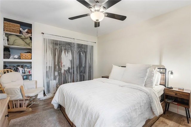 bedroom with ceiling fan and wood finished floors