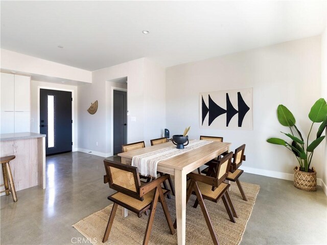 dining area featuring concrete flooring