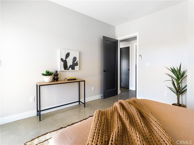 bedroom featuring concrete floors