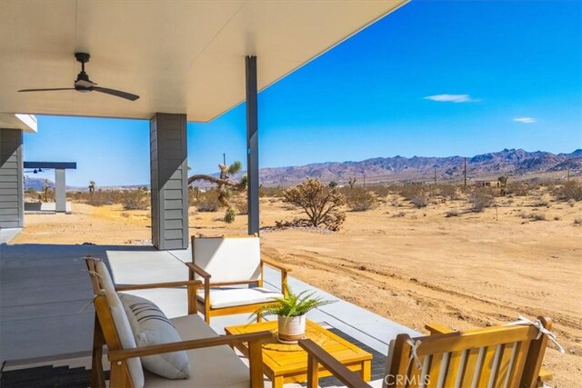 view of patio with a mountain view and ceiling fan