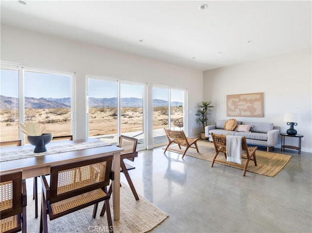 dining room with a mountain view and concrete floors