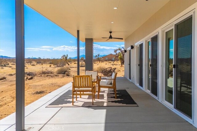 view of patio featuring ceiling fan