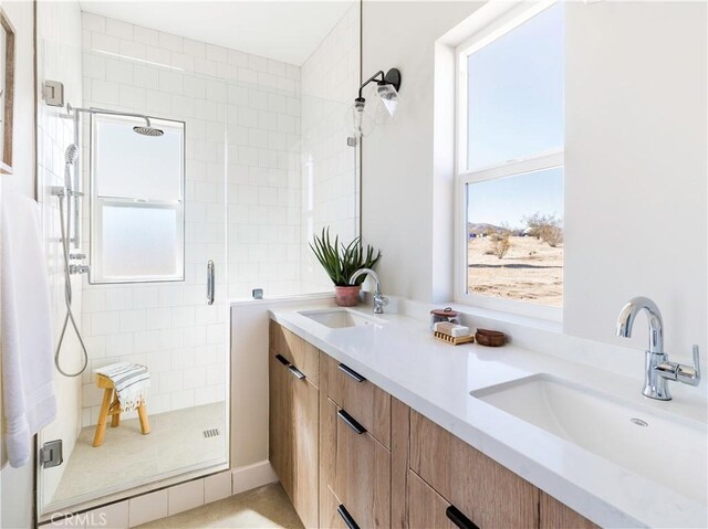 bathroom featuring vanity and a shower with shower door