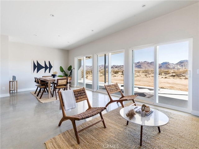 living area with concrete flooring and a mountain view