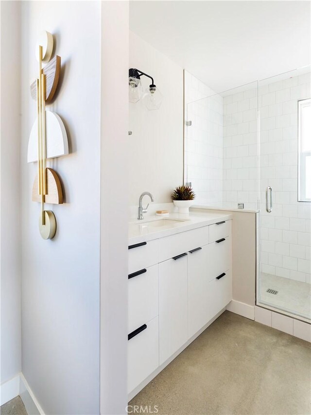 bathroom with vanity and a shower with door