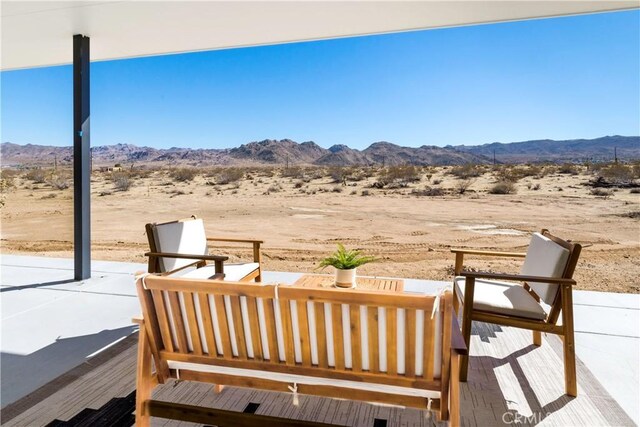 view of patio / terrace with an outdoor hangout area and a mountain view