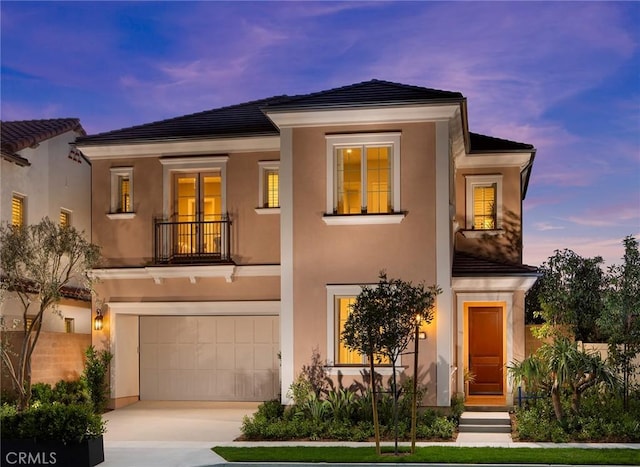 view of front of property with a garage and a balcony