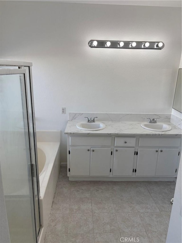 bathroom featuring independent shower and bath, vanity, and tile patterned floors