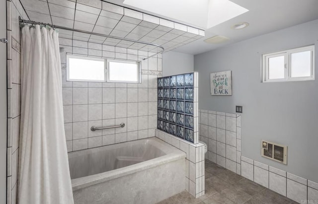 bathroom featuring tile patterned flooring, tile walls, and shower / bath combo