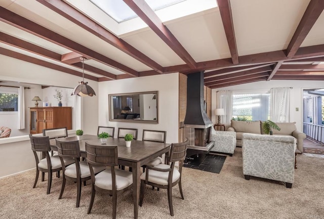 dining room featuring vaulted ceiling with skylight and a wealth of natural light