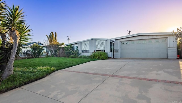 view of front of property with a yard and a garage