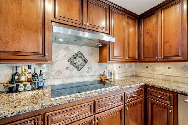 kitchen featuring tasteful backsplash, light stone countertops, and black electric stovetop