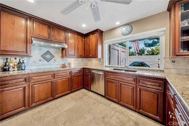 kitchen featuring sink, light stone counters, black electric cooktop, decorative backsplash, and stainless steel dishwasher