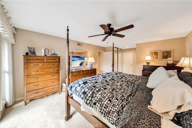 bedroom with light carpet and ceiling fan