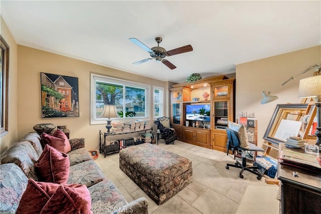 living room featuring ornamental molding and ceiling fan