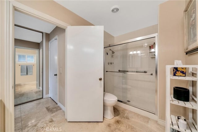 bathroom with walk in shower and toilet