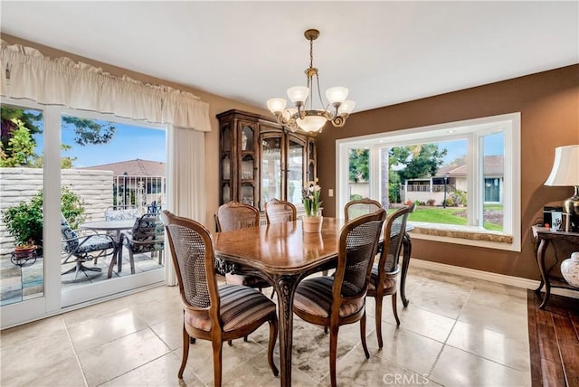 dining area with an inviting chandelier and light tile patterned floors