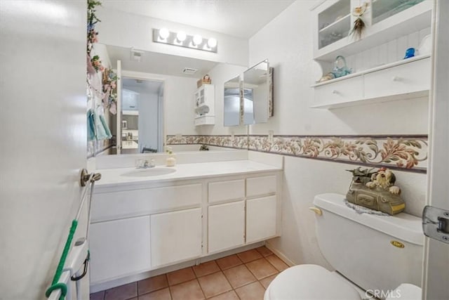 1308 Pleasant Valley Ave, Banning, CA 92220 - bathroom featuring a wainscoted wall, vanity, toilet, and tile patterned floors