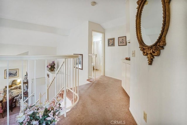 1308 Pleasant Valley Ave, Banning, CA 92220 - hallway featuring lofted ceiling, light colored carpet, and an upstairs landing